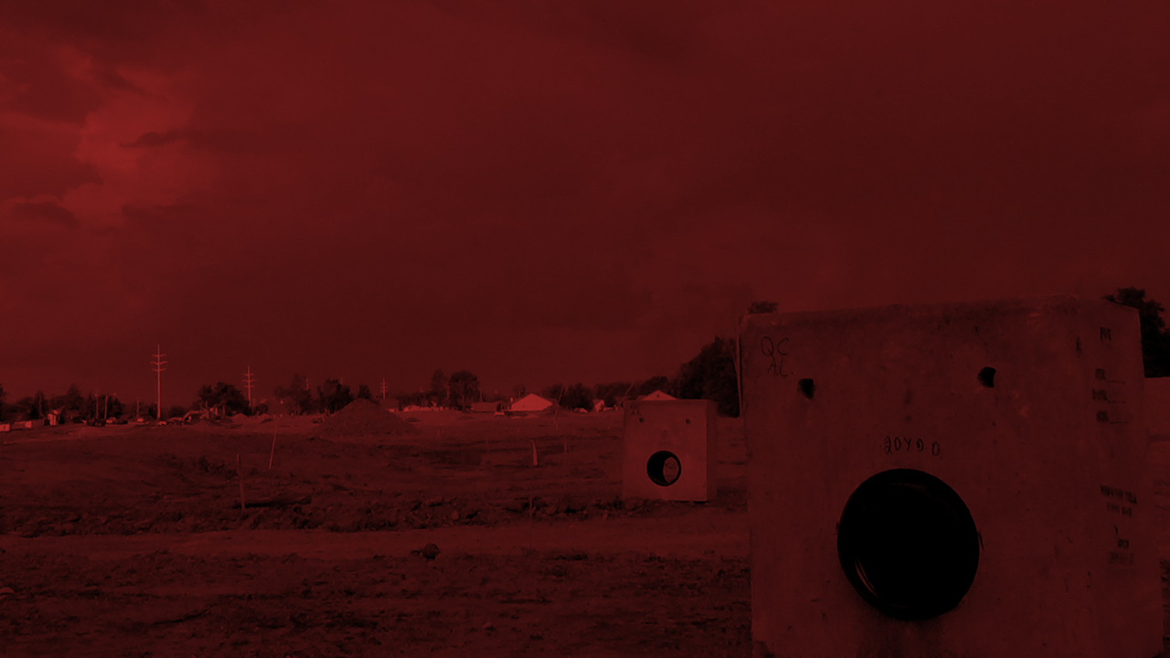 Dark red overlay image of a construction site